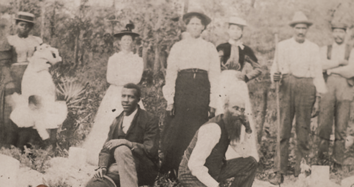 John Henry Monroe, left, and Martine Goins, right, kneel at the funeral of Eli Waldron, Goins’ brother-in-law, in 1900 in Rosewood, Florida. Behind them stand Sophie Goins Monroe, her mother and Lydia Goins, the sister of Eli Waldron. (Courtesy of the Rosewood Heritage foundation/Marie Monroe Ames)