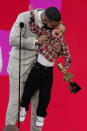 Drake carries his son Adonis Graham as he accepts the artist of the decade award at the Billboard Music Awards on Sunday, May 23, 2021, at the Microsoft Theater in Los Angeles. (AP Photo/Chris Pizzello)