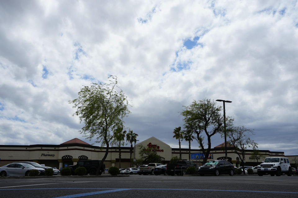 The parking lot of a shopping plaza where Priscilla Orr died due to extreme heat in 2023, is shown Friday, April 5, 2024, in Avondale, Ariz. Orr, 75, was living in her old, white Kia in a supermarket parking lot after telling her family she lost her money and home to a romance scam, but the car couldn't protect her from the dangerous desert heat after it broke down, rendering its air conditioner useless. Orr collapsed July 10 as she walked on the lot's scalding asphalt, which registered 149 degrees Fahrenheit (65 C). (AP Photo/Ross D. Franklin)