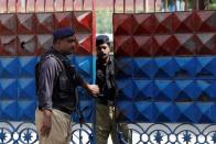 Police officers stand guard at the entrance of the Central Prison in Karachi