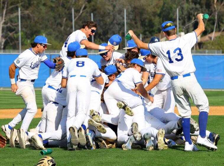 Santa Margarita baseball players celebrate their 3-2 win over La Costa Canyon in the Southern California Regional Division I championship game Saturday at Santa Margarita High School.