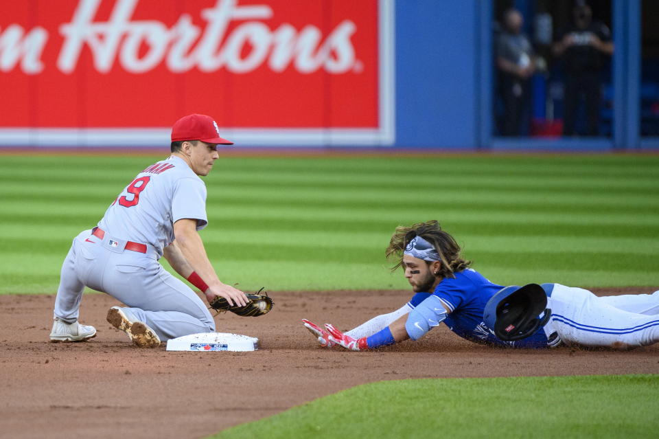 Toronto Blue Jays' Bo Bichette (11) safely slides into second base past St. Louis Cardinals shortstop Tommy Edman (19) for a double during the first inning of a baseball game, Tuesday, July 26, 2022 in Toronto. (Christopher Katsarov/The Canadian Press via AP)