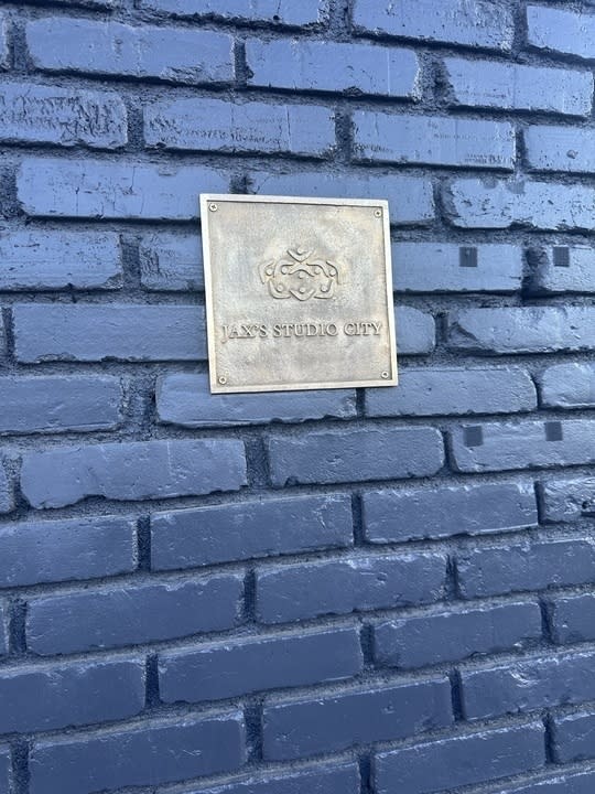 Plaque with "SAS STUDIO CITY" embossed, mounted on a brick wall