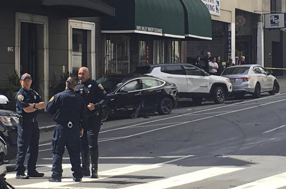 FILE - This Sunday, July 21, 2019 file photo, and provided by KGO-TV shows the scene after a woman was arrested after running a red light in a rented Tesla in San Francisco and causing a crash that killed a tourist and left his wife critically injured. San Francisco police said Wednesday, July 24, 2019, preliminary information shows a rented Tesla that was speeding when it ran a red light and struck a couple, was not on semi-autonomous Autopilot mode. (Kate Larsen/KGO-TV via AP,File)