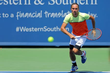 Aug 12, 2017; Mason, OH, USA; Alexandr Dolgopolov (UKR) charges the net against Reilly Opelka (USA) during the Western and Southern Open at Lindner Family Tennis Center. Mandatory Credit: Aaron Doster-USA TODAY Sports