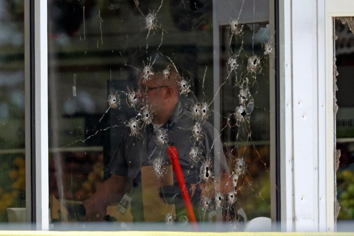 <span>A law enforcement officer works behind a bullet-riddled window at the Mad Butcher grocery store in Fordyce, Arkansas, on 21 June 2024.</span><span>Photograph: Colin Murphey/AP</span>