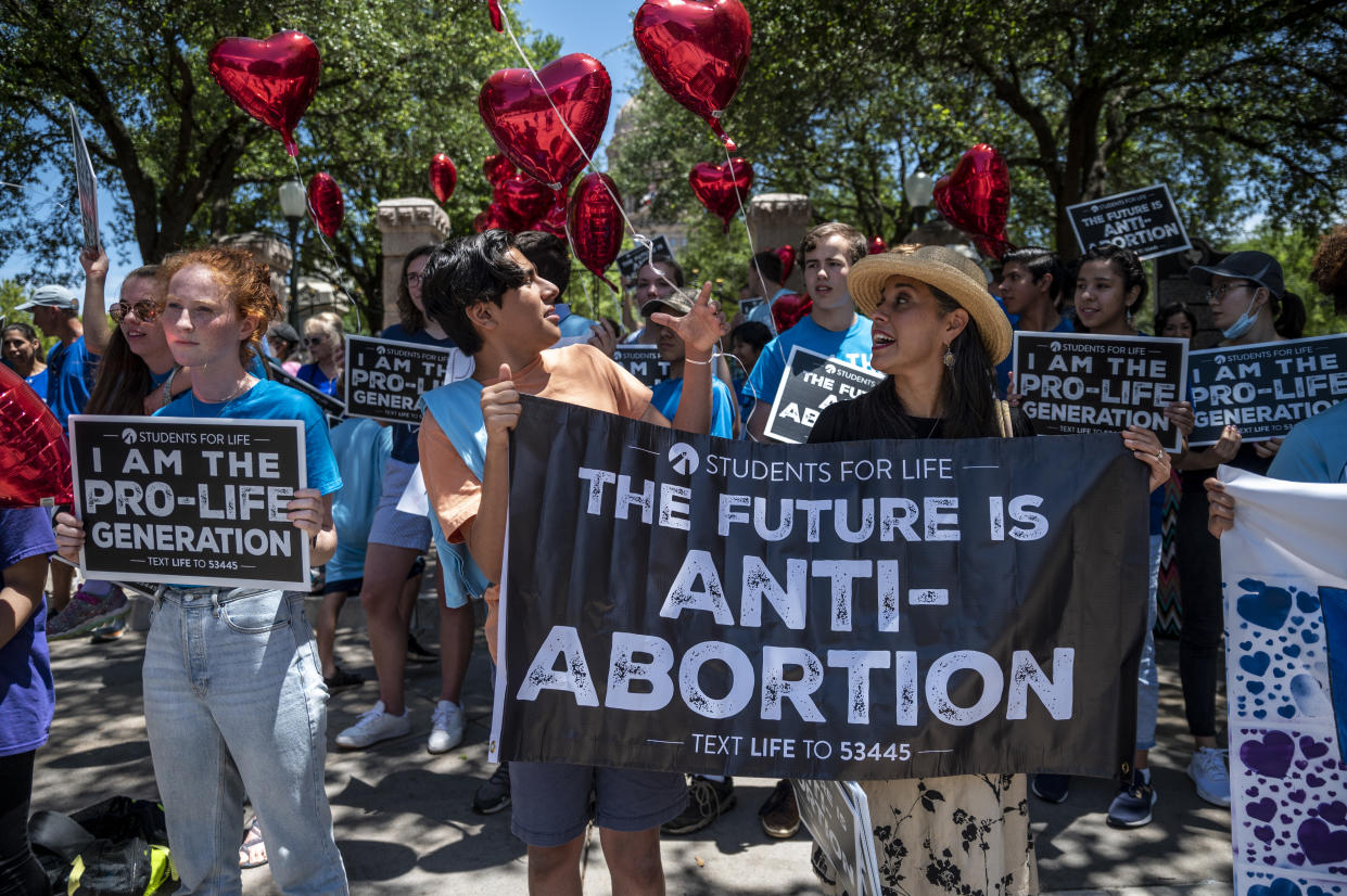 Opponents of abortion carrying signs like 