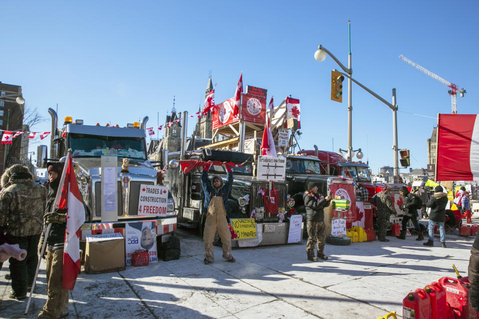 FILE- Drivers parked their trucks blocking lanes of traffic to protest against pandemic restrictions in Ottawa, Ontario, on Monday, Feb. 14, 2022. A public commission announced Friday, Feb. 17, 2023, that Canadian Prime Minister Justin Trudeau’s government met the “very high threshold” for invoking the Emergencies Act to quell the protests by truckers and others angry over Canada’s COVID-19 restrictions last winter. (AP Photo/Ted Shaffrey, File)