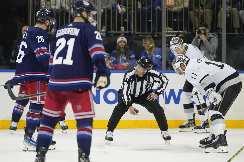 A referee (51) speaks to New York Rangers left wing Jimmy Vesey (26) before a face off against Los Angeles Kings center Anze Kopitar (11) during the second period of an NHL hockey game in New York, Sunday, Dec. 10, 2023. (AP Photo/Peter K. Afriyie)