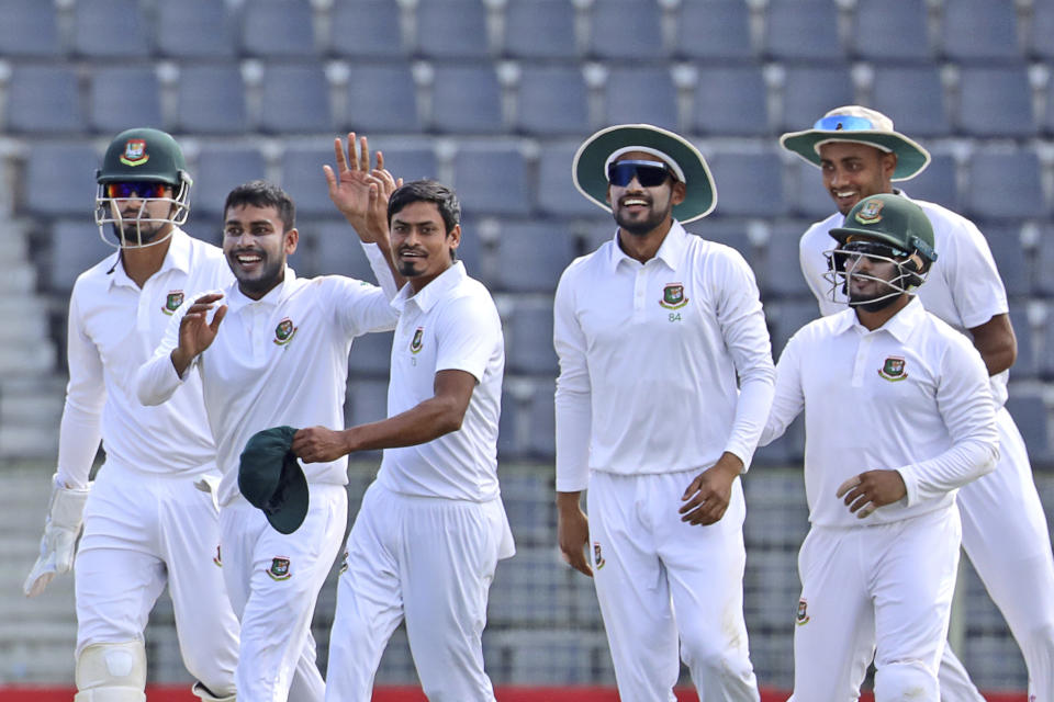 Bangladeshi cricketers celebrate after the dismissal of New Zealand batter Devon Conway during the second day of the first test cricket match at Sylhet, Bangladesh, Wednesday, Nov. 29, 2023. (AP Photo/Mosaraf Hossain)