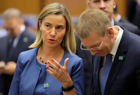 European Union foreign policy chief Federica Mogherini speaks with a delegate before the start of the "Meeting of the Ministers of the Global Coalition to Counter ISIL: Joint Plenary Session" at the State Department in Washington, U.S., July 21, 2016. REUTERS/Joshua Roberts