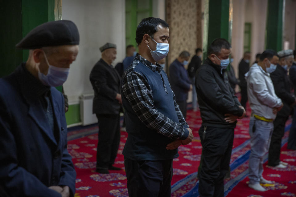 Uyghurs and other members of the faithful pray during services at the Id Kah Mosque in Kashgar in western China's Xinjiang Uyghur Autonomous Region, as seen during a government organized visit for foreign journalists on April 19, 2021. Under the weight of official policies, the future of Islam appears precarious in Xinjiang, a remote region facing Central Asia in China's northwest corner. Outside observers say scores of mosques have been demolished, which Beijing denies, and locals say the number of worshippers is on the decline. (AP Photo/Mark Schiefelbein)