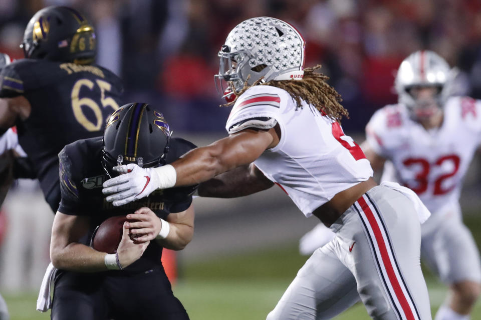 Ohio State defensive end Chase Young, right, sacks Northwestern quarterback Aidan Smith during the first half of an NCAA college football game Friday, Oct. 18, 2019, in Evanston, Ill. (AP Photo/Charles Rex Arbogast)