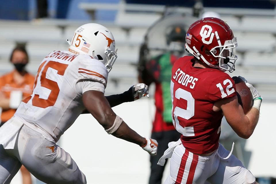 OU receiver Drake Stoops (12) runs to the end zone past Texas' Chris Brown (15) in the fourth overtime of the 2020 Red River Showdown at the Cotton Bowl in Dallas. The Sooners won 53-45.
