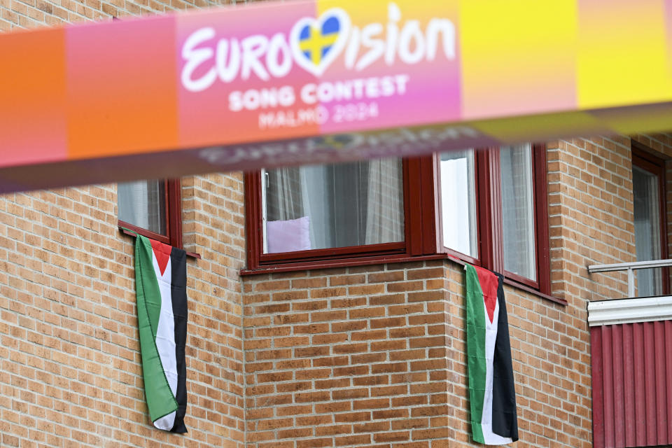 Palestinian flags hang from windowsills on a building near the entrance of the Eurovision Village, a fan zone that will host music performances and live broadcast of the Eurovision Song Contest, in Folkets Park in Malmo, Sweden on May 4, 2024. A week of Eurovision Song Contest festivities kicked off Saturday, on May 4, in the southern Swedish town of Malmo, with 37 countries taking part. The first semi-final takes place on Tuesday, May 7, the second on Thursday, May 9, and the grand final concludes the event on May 11. Thousands of people are expected to attend pro-Palestinian rallies throughout the week in Malmo. (Photo by Johan Nilsson/TT / TT News Agency / AFP) / Sweden OUT (Photo by JOHAN NILSSON/TT/TT News Agency/AFP via Getty Images)