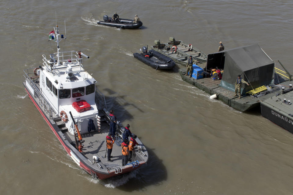 Rescue boats float on the Danube river where a sightseeing boat had capsized in Budapest, Hungary, Saturday, June 1, 2019. Rescue operations continue Saturday, and Hungarian authorities predicted it would take an extended search to find the 21 people still missing after a boat carrying South Korean tourists was rammed Wednesday night by a cruise ship and sank. (AP Photo/Marko Drobnjakovic)