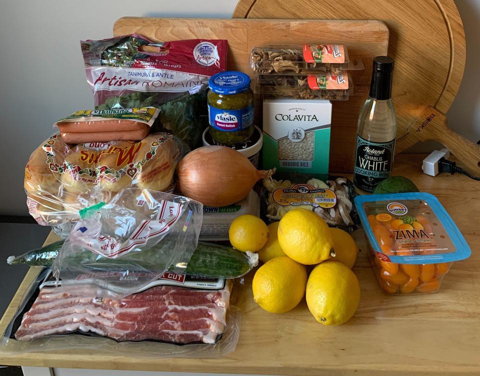 A collection of groceries on a wooden table.