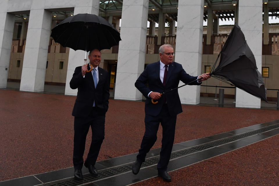 CANBERRA, AUSTRALIA - OCTOBER 07: Treasurer Josh Frydenberg and Prime Minister Scott Morrison arrives for media appearances in the forecourt lawn at Parliament House on October 07, 2020 in Canberra, Australia. The Morrison government's second budget was published on Tuesday, after its release in May was delayed by the COVID-19 pandemic. Treasurer Frydenberg has delivered a federal budget deficit of $213.7 billion in the wake of coronavirus and related shutdowns, with a number of tax cuts to be introduced to help boost the economy and create jobs as Australia experiences its first recession in 29 years.  (Photo by Sam Mooy/Getty Images)