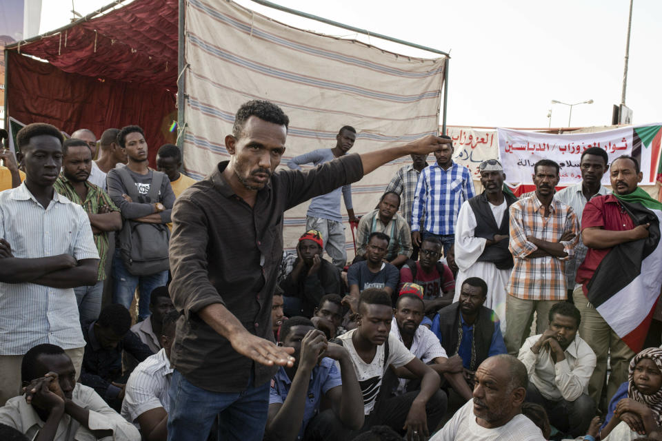 A protester gives a speech to others during a sit-in at Armed Forces Square in Khartoum, Sudan, Saturday, April 27, 2019. The Umma party of former Prime Minister Sadiq al-Mahdi, a leading opposition figure, said the protesters will not leave until there is a full transfer of power to civilians. (AP Photos/Salih Basheer)