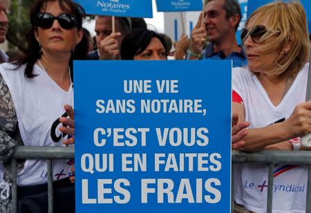Notaries and bailiffs hold placards as they demonstrate during their first-ever public protest against a plan to chip away at rules shielding them from competition in Marseille September 17, 2014. REUTERS/Jean-Paul Pelissier