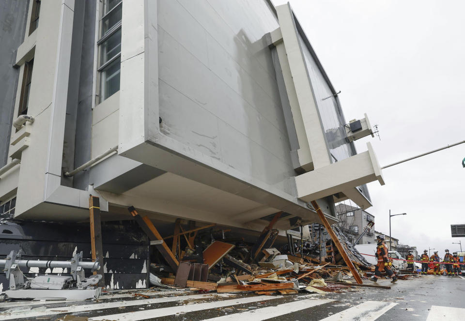 Firefighters search a fallen building hit by earthquakes in Wajima, Ishikawa prefecture, Japan Wednesday, Jan. 3, 2024. (Kyodo News via AP)