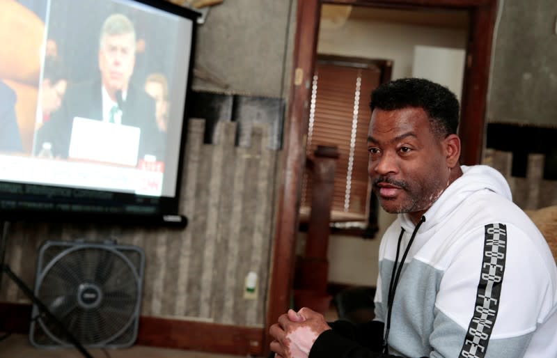 Voter Quincy Murphy watches the public hearing held by the House Permanent Select Committee on Intelligence as part of the impeachment inquiry into U.S. President Donald Trump, in his home in Flint