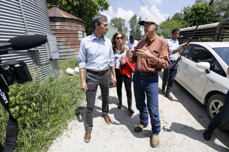 Democratic presidential candidate Beto O'Rourke talks with Matt Russell, right, while touring his Coyote Run Farm, Friday, June 7, 2019, in Lacona, Iowa. (AP Photo/Charlie Neibergall)