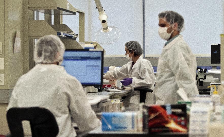 In this April 15, 2014 photo, criminalist trainees work at a lab in the Office of Chief Medical Examiner in New York. With new technology yielding results impossible a dozen years ago, forensic scientists are still trying to match the bone with DNA from those who died on Sept. 11, 2001, and have never been identified. (AP Photo/Bebeto Matthews)