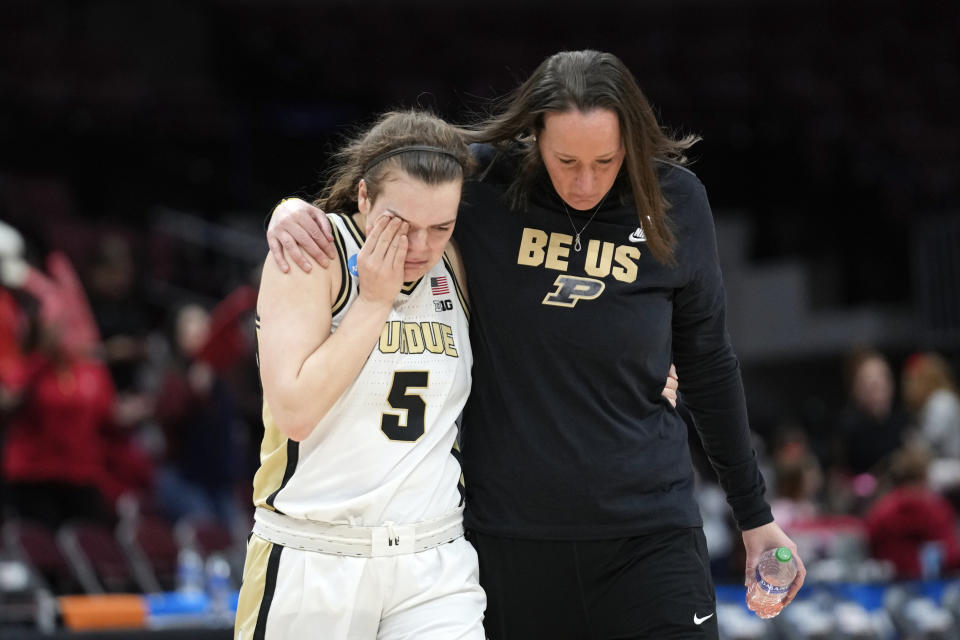 Purdue guard Cassidy Hardin (5) walks off the court with head coach Katie Gearlds after a First Four women's college basketball game against St. John's in the NCAA Tournament Thursday, March 16, 2023, in Columbus, Ohio. St. John's won 66-64. (AP Photo/Paul Sancya)