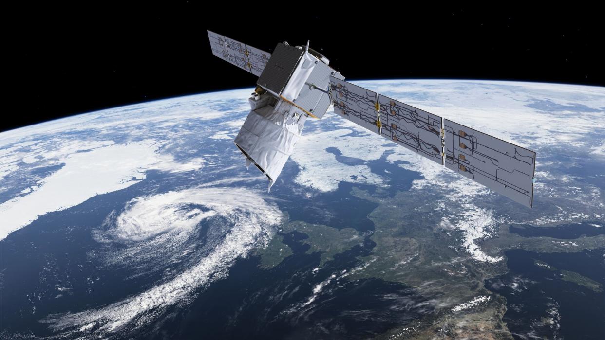  An illustration shows the Aeolus wind satellite over Earth. 