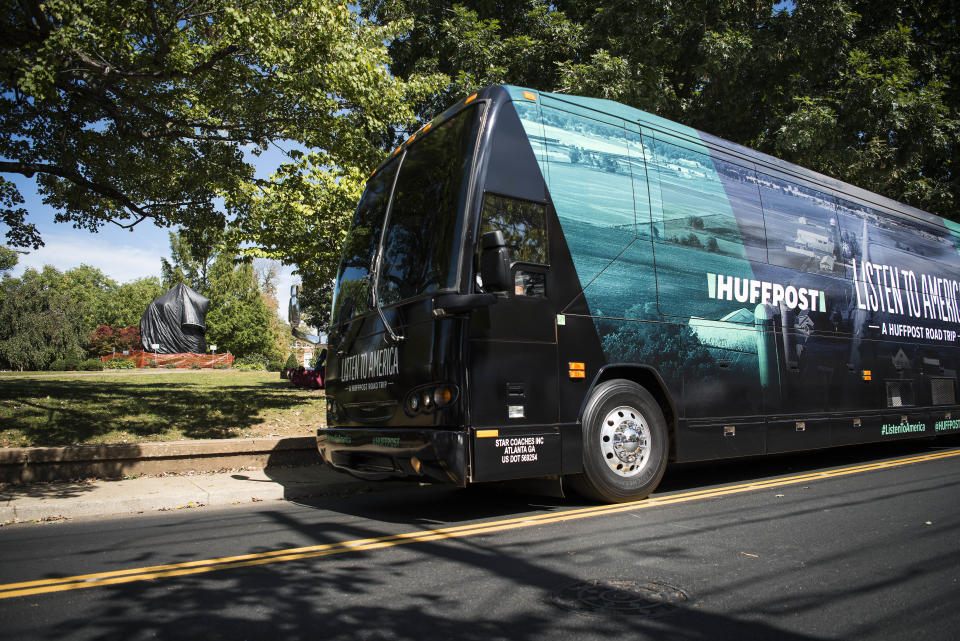 The HuffPost bus sits in front of the Robert E. Lee statue, which is covered in plastic, in Charlottesville, Virginia, on Sept. 26, 2017.