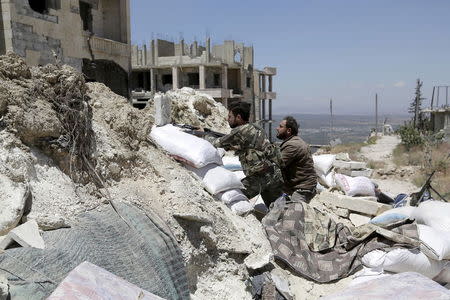 Rebel fighters from the Ahrar al-Sham Islamic Movement take positions behind sandbags in Jabal al-Arbaeen, which overlooks the northern town of Ariha, one of the last government strongholds in the Idlib province May 26, 2015. REUTERS/Khalil Ashawi