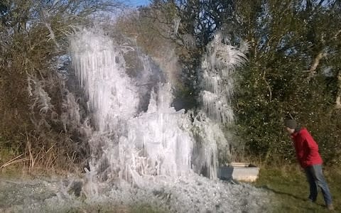 A burst water main which froze in a west Wales field has created this stunning ice sculplure - Credit: Hannah Mitchell 