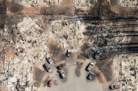 <p>In this aerial view, a burned neighborhood is seen in Santa Rosa, Calif., on Oct. 12, 2017. (Photo: Josh Edelson/AFP/Getty Images) </p>
