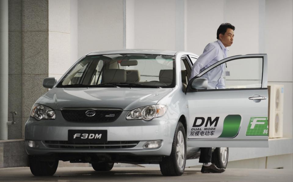 A driver gets out of a BYD Auto F3DM hybrid car at its headquarters in the southern Chinese city of Shenzhen on February 17, 2009. BYD Auto is pursuing a project to free cars from their century-old dependence on gasoline and next month will start delivering the F3DM -- DM stands for 