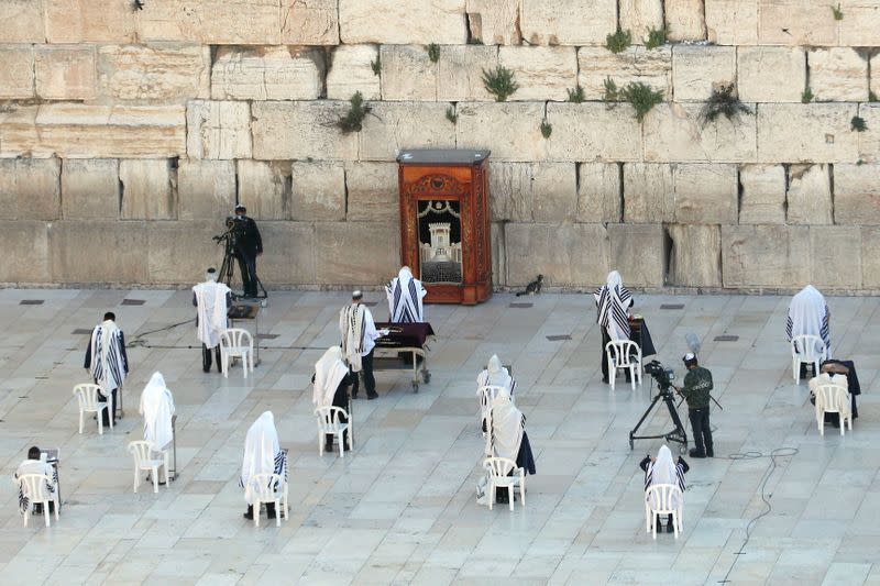 A small number of Jewish worshippers pray during the priestly blessing, a traditional prayer which usually attracts thousands of worshippers at Western Wall on Passover, amid the coronavirus disease (COVID-19) outbreak in Jerusalem's Old City