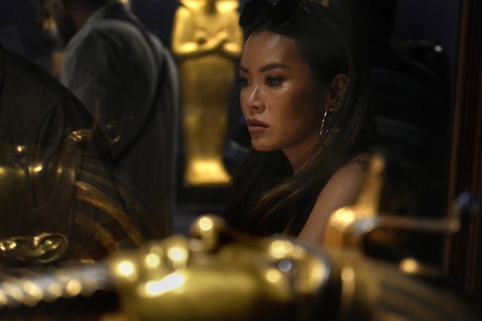 A Toursit watches king tutankhamun sarcophagus at the Egyptian Museum in Cairo, Egypt, Wednesday, Sept. 27, 2023. Egypt is aiming at reaching 30 million visitors by 2028, as its once-thriving tourism sector has begun to recover from the fallout of the coronavirus pandemic and the grinding war in Europe, Egypt's Tourism and Antiquities Minister Ahmed Issa said during an interview with the Associated Press. (AP Photo/Amr Nabil)