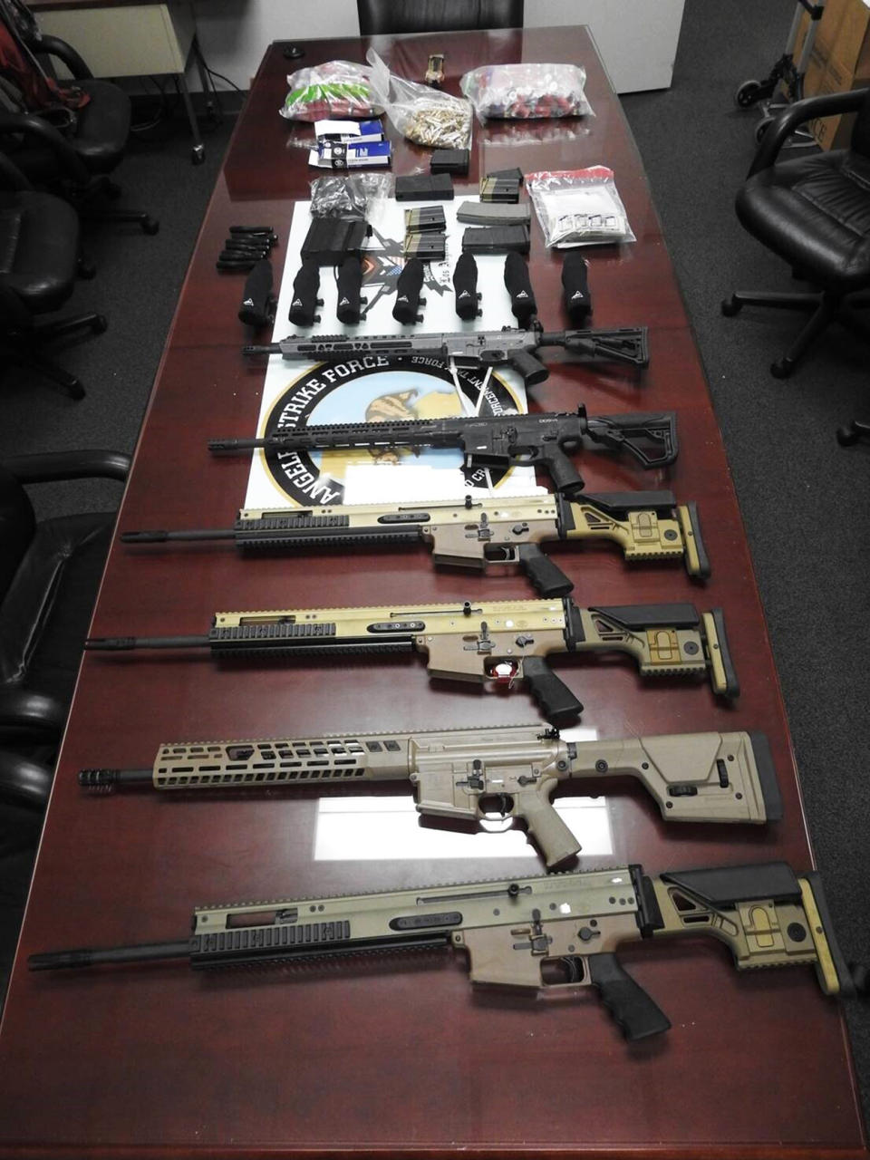 High-powered firearms and ammunition in an undated photo provided by the Justice Department. (U.S. Justice Department via AP)