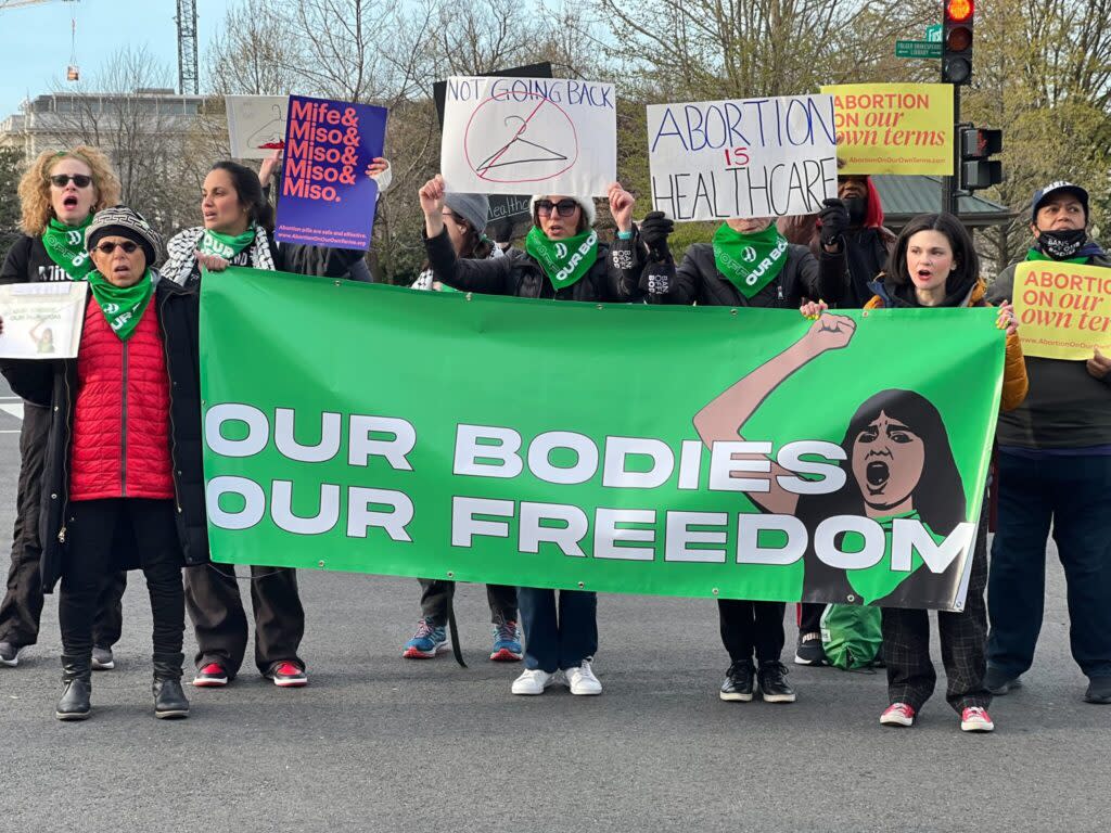 Protestors holding a banner saying "Our Bodies Our Freedom"