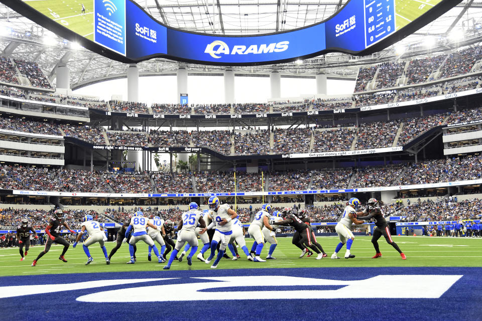 Los Angeles Rams quarterback Matthew Stafford (9) hands off to running back Sony Michel (25) during the first half of an NFL football game Sunday, Sept. 26, 2021, in Inglewood, Calif. (AP Photo/Kevork Djansezian)