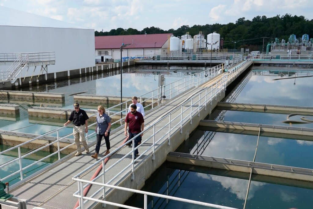 Jim Craig, with the Mississippi State Department of Health, left, leads Jackson Mayor Chokwe Antar Lumumba, right, Deanne Criswell, administrator of the Federal Emergency Management Agency (FEMA), center, and Mississippi Gov. Tate Reeves, rear, as they walk past sedimentation basins at the City of Jackson’s O.B. Curtis Water Treatment Facility in Ridgeland, Miss., Friday, Sept. 2, 2022. Jackson’s water system partially failed following flooding and heavy rainfall that exacerbated longstanding problems in one of two water-treatment plants. (AP Photo/Rogelio V. Solis, Pool)