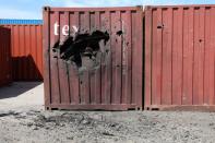 A damaged container is seen at Tripoli port after an attack