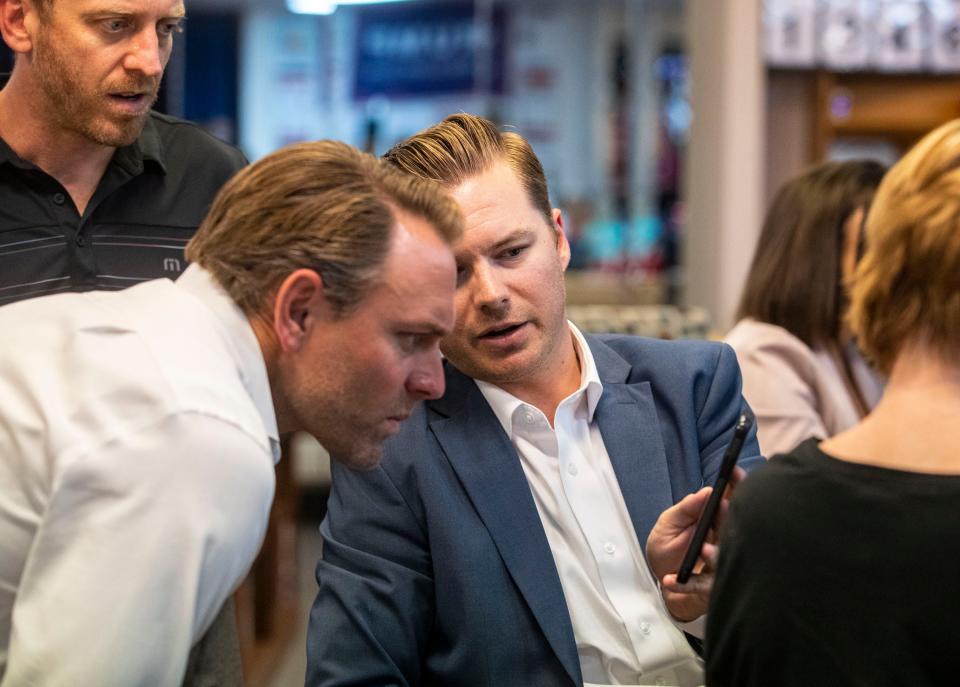 Assembly District 47 candidate Greg Wallis (center) shows early results to Ian Weeks (left) in his race for California's Assembly District 36 during an election results watch party at the East Valley Republican Women Patriots headquarters in La Quinta, Calif., Tuesday, June 7, 2022.