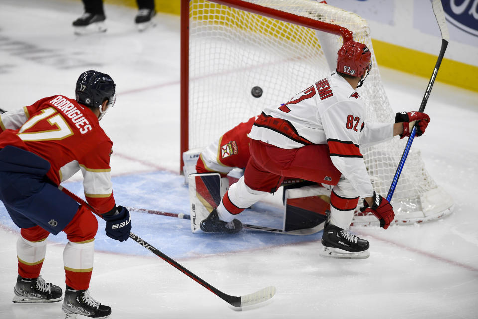 Carolina Hurricanes center Jesperi Kotkaniemi (82) scores a goal on Florida Panthers goaltender Sergei Bobrovsky during the first period of an NHL hockey game Friday, Nov. 10, 2023, in Sunrise, Fla. (AP Photo/Michael Laughlin)