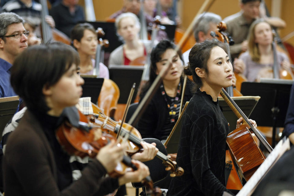 Members of North Korea's Unhasu Orchestra, right, take part to a rehearsal with the Radio France Philharmonic Orchestra in Paris, Tuesday, March 13, 2012. Musicians from the Unhasu Orchestra will perform a piece together with Radio France Philharmonic Orchestra, directed by South Korean conductor Chung Myung-whun, in Paris, Wednesday, March 14. (AP Photo/Remy de la Mauviniere)