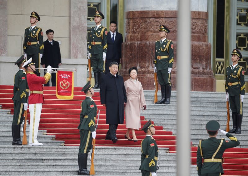 Chinese President Xi Jinping and his wife Peng Liyuan arrive to attend a welcoming ceremony for French President Emmanuel Macron and his wife Brigitte Macron in Beijing