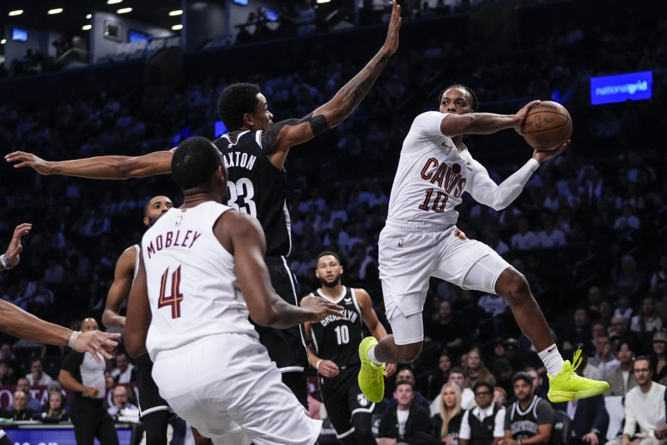 Cleveland Cavaliers' Darius Garland (10) passes the ball away from Brooklyn Nets' Nic Claxton (33) during the first half of an NBA basketball game Wednesday, Oct. 25, 2023, in New York. (AP Photo/Frank Franklin II)