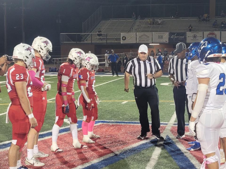Captains for the Arcadia Titans (left) meet captains for the Mesquite Wildcats prior to kickoff of their 4A game at Arcadia High School on Friday, Oct. 6, 2023.