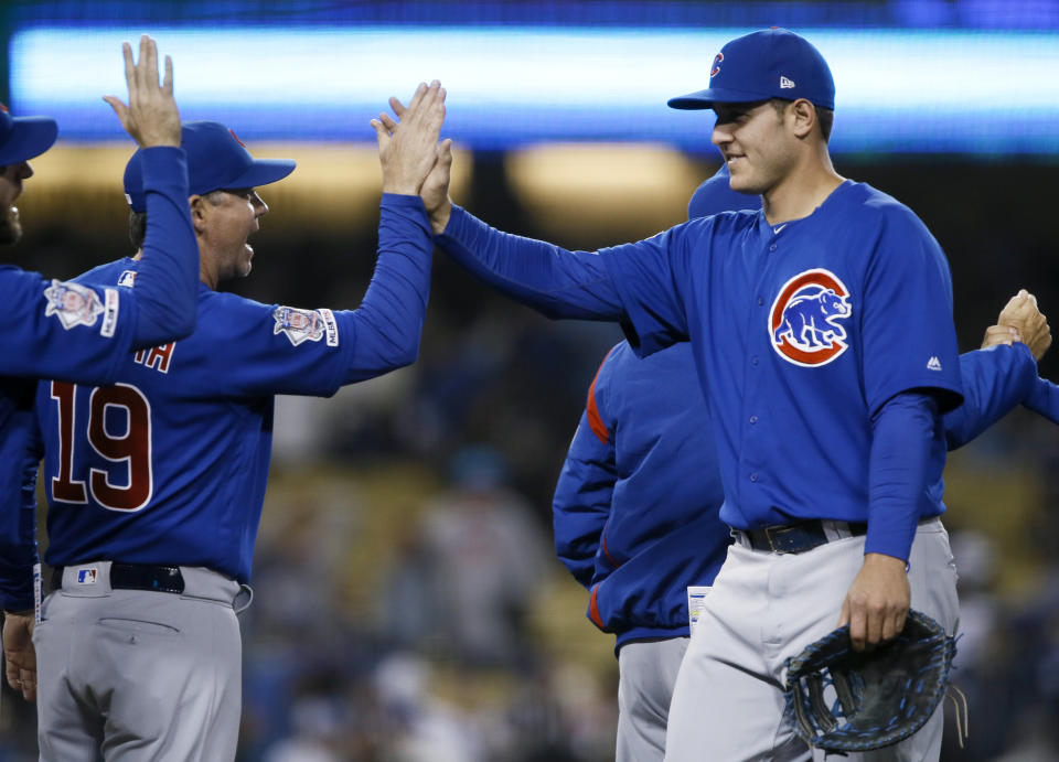 Chicago Cubs' Anthony Rizzo, right, celebrates with bench coach Mark Loretta (19) after the Cubs defeated the Los Angeles Dodgers 2-1 in a baseball game in Los Angeles, Saturday, June 15, 2019. (AP Photo/Alex Gallardo)