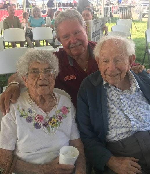 James B. Miller, master of ceremonies for the Senior Citizens Day awards' program at the Monroe County Fair, stands behind Marion Yoas and Erv Yoas, winners of trophies for being the oldest woman and man, respectively, at the 2022 fair.